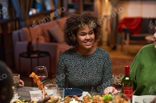 Preview: Woman sitting at dining table