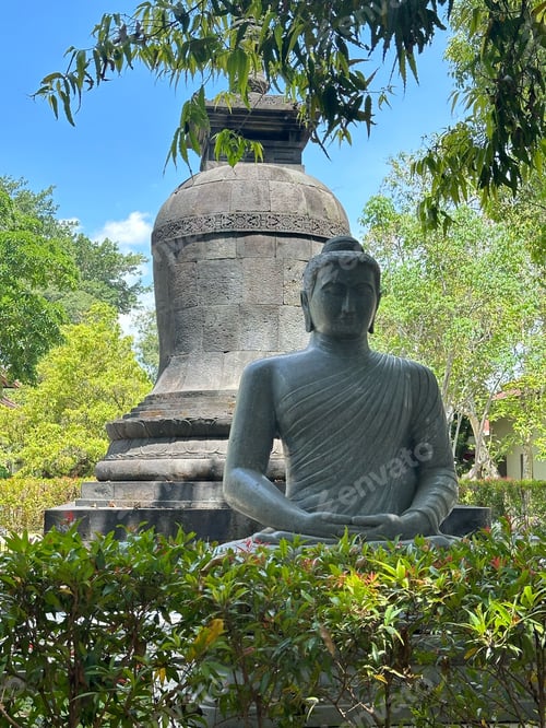 Preview: Serene Buddha statue in a lush garden setting.