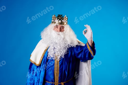 Preview: Magician King making the Ok gesture on a blue background