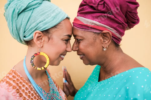 Preview: Happy african mother and daughter with forehead together and smiling