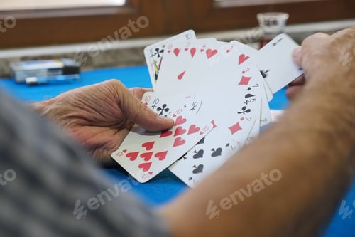Preview: Playing cards at a table on a sunny afternoon