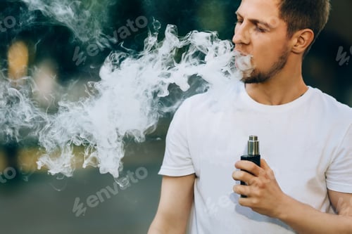Preview: Modern young man with a beard fun Vaporizers Outdoor.
