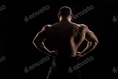 Preview: back view of young shirtless athlete flexing back muscles