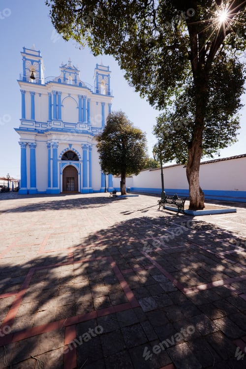 Preview: Church in a town square and a shady bench under a tree