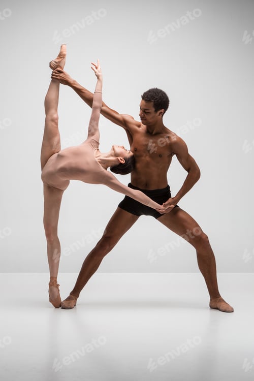 Preview: Couple of ballet dancers posing over gray background