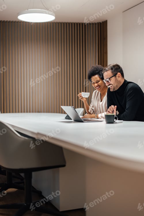 Preview: Distand shot of business partners, quietly working in the conference room together.