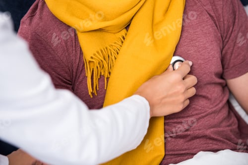 Preview: cropped shot of female doctor using stethoscope to listen to patients breath