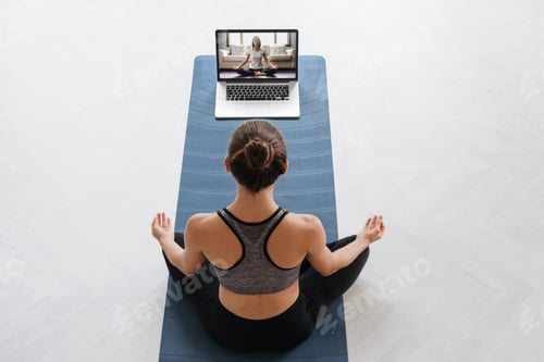 Preview: Woman Practicing Yoga with Online Video