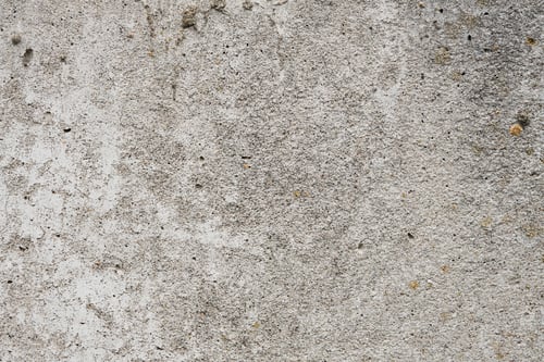 Preview: Cracked concrete wall covered with gray cement surface. Grey old wall with shabby damaged plaster or