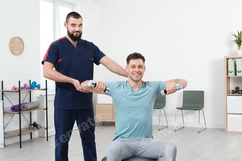 Preview: Physiotherapist working with patient in clinic. Rehabilitation therapy