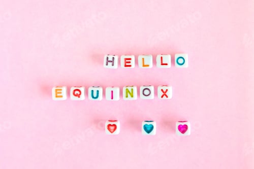 Preview: Text “Hello equinox” made from colorful beads on pastel pink background, top view, closeup, flatlay