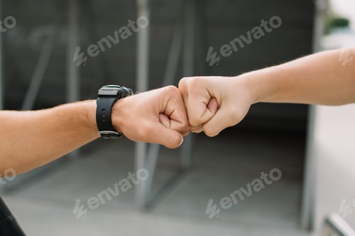 Preview: Two teen boys giving fist bump at meeting each other.