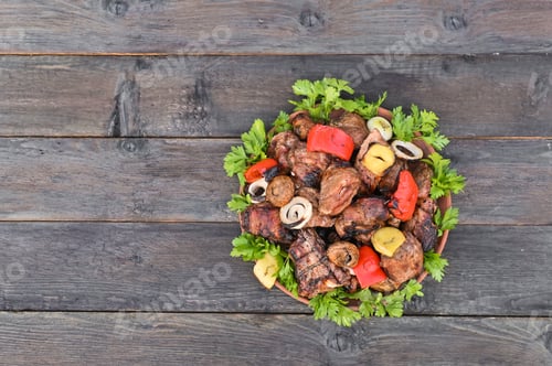 Preview: Barbecue with vegetables and herbs on a plate.