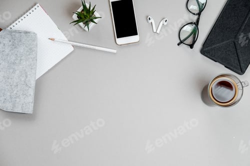 Top view of stationery and telephone, coffee on grey desktop background. Business concept