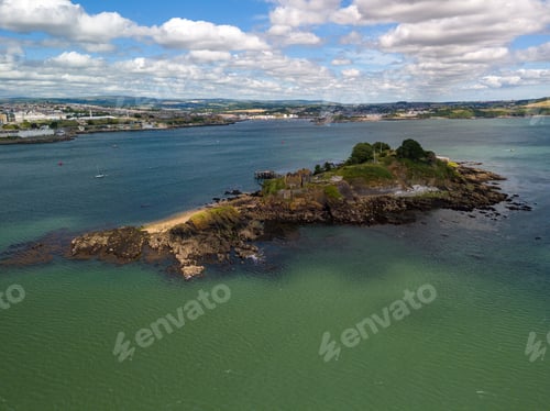 Preview: Drake's Island in Plymouth Sound, England with the city in the background and a partly cloudy sky