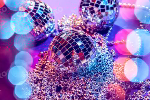 Preview: Shiny small disco balls sparkling in a beautiful purple light. Disco party concept