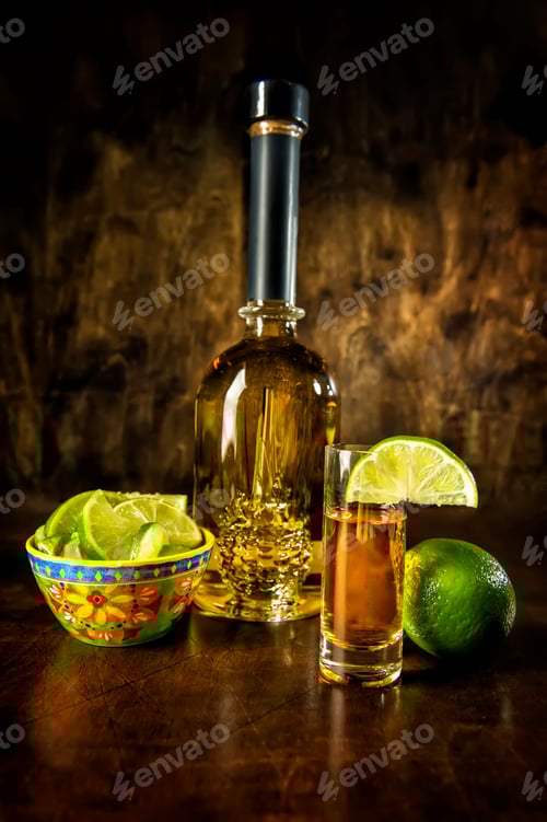 Preview: Tequila bottle with shot glass and limes