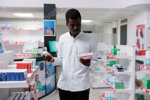 Preview: Young african american man choosing heart medication in drugstore