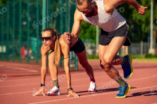 Preview: Woman and man jogging in the stadium