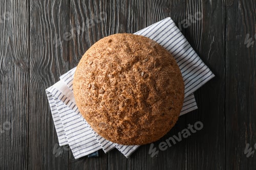 Preview: Bread on kitchen towel on wooden background, space for text and top view