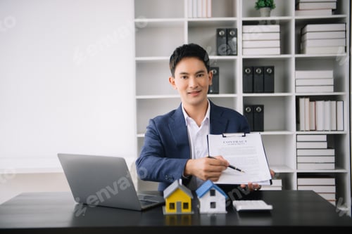 Preview: Asian man working with House model real estate agent and customer discussing for contract