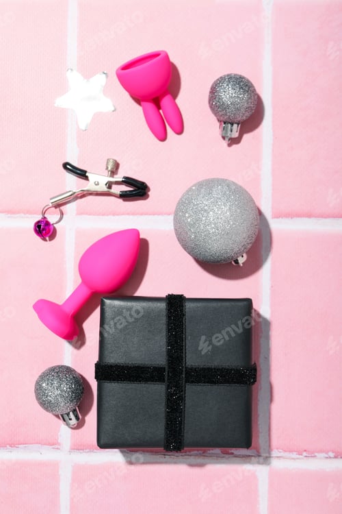 Preview: Sex toys with Christmas gifts on the background.