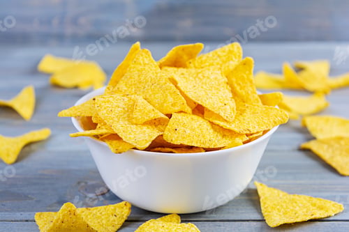 Preview: Mexican nachos with cheese. Corn chips isolated on wooden background