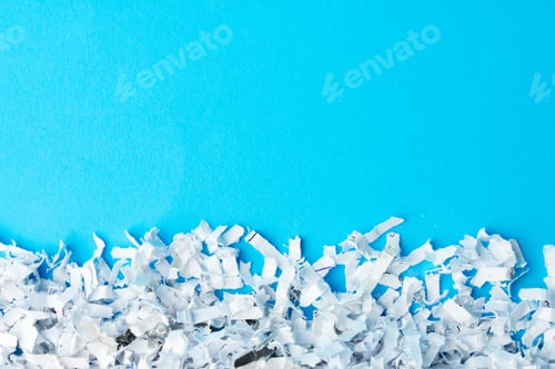 Preview: Shredded paper pieces on a blue background