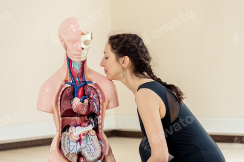 Preview: A Yoga Coach Sits Next To A Medical Dummy