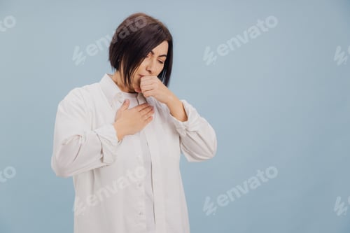 Preview: Middle aged woman suffering from cough and chest pain on blue background