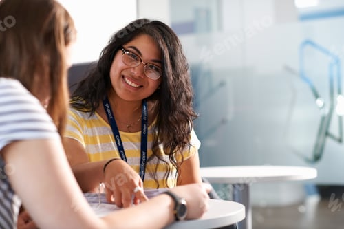 Preview: Two teenage girls working together in class