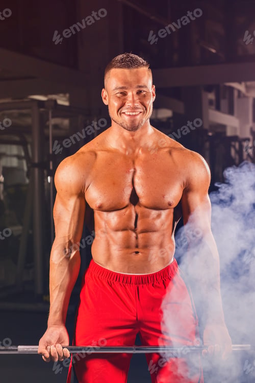 Preview: Bodybuilder doing the exercises with barbell. Strong male with naked torso on dark background