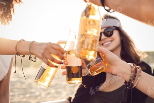 Preview: Group of happy young people sitting together at the beach