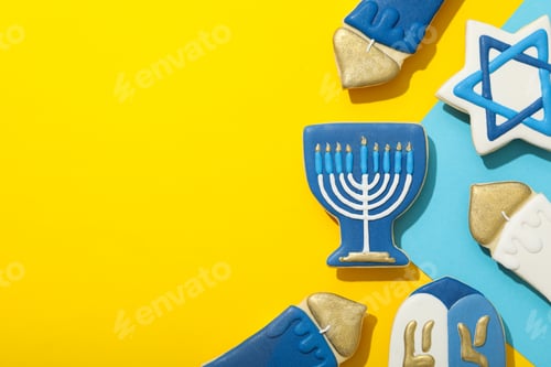 Preview: Gingerbread cookies with Jewish symbols on yellow background, space for text