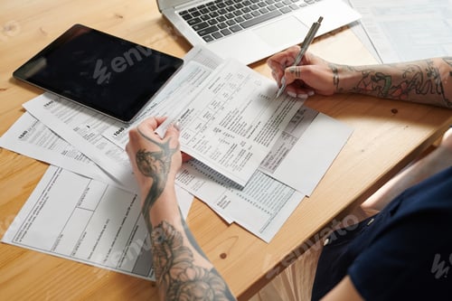 Preview: Woman filling bills and bank statements