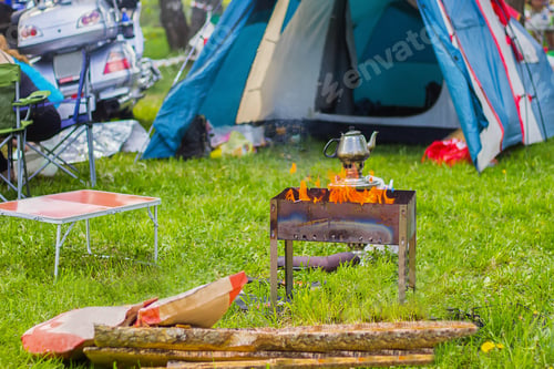 Preview: View of camping in nature. Cooking over a campfire