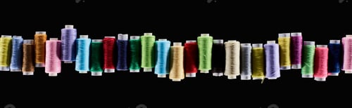 Preview: panoramic shot of bright and colorful threads isolated on black