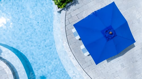 Preview: Top view swimming pool blue water in summer with umbrella pool and deck beach chair.