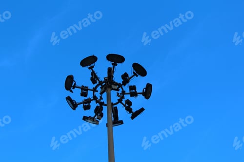 Preview: Vertical metal pole with lights under a blue sky