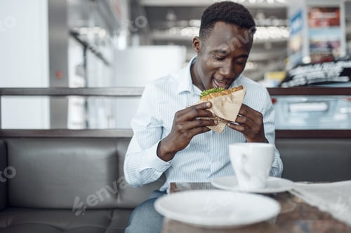 Preview: A businessman eating sandwich in car showroom