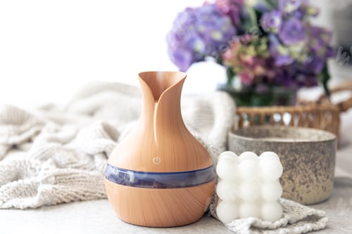 Preview: Spa composition with aroma oil diffuser lamp and candle on a blurred background.