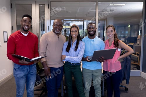 Preview: Portrait of smiling biracial advisor's team in boardroom during meeting at modern workplace