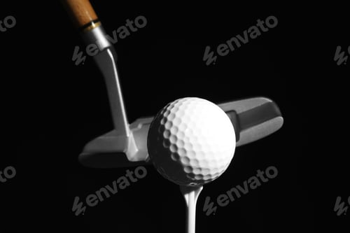 Preview: Golf club and ball against dark background
