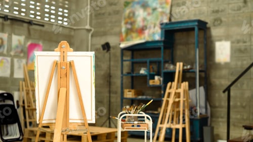 Preview: Stylish art studio with a blank canvas surrounded by painting supplies.