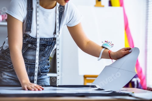 Preview: The tailor working with a fabric on the table