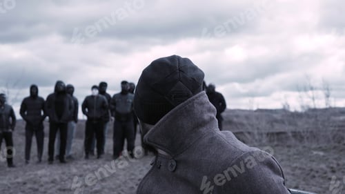 Preview: Man sits in a chair and looks at a group of masked criminals. Footage. A meeting place for gangsters