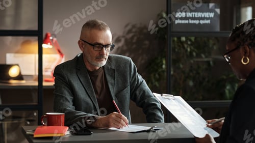 Preview: Manager examining resume of candidate