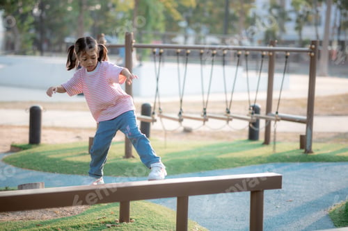 Preview: A little girl is playing on a park equipment