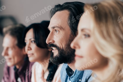 Preview: side view of male and female middle aged friends looking away