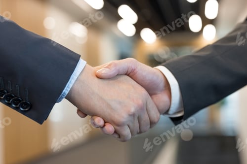 Preview: Business men shaking hands making a successful deal